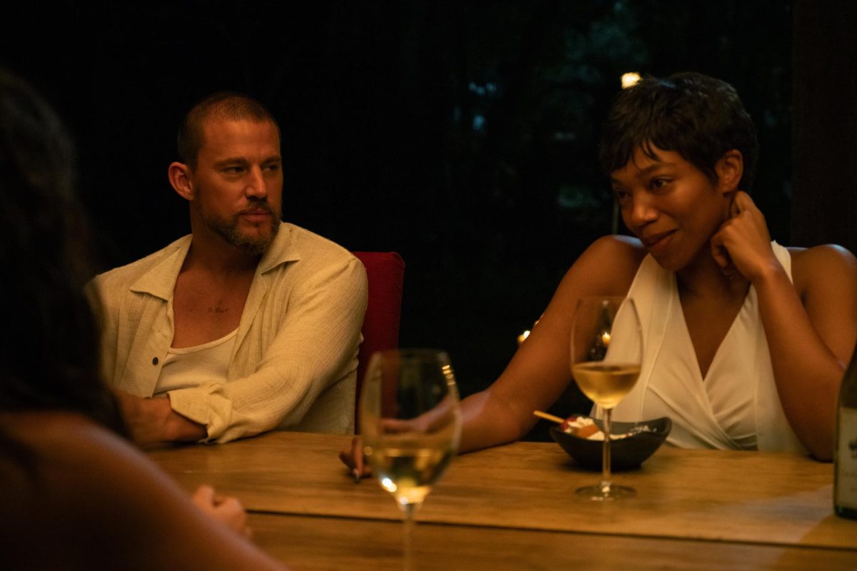 Channing Tatum as Slater King (left) and Naomi Ackie as Frida (right) are pictured at a dinner party scene during the movie. Zoë Kravitz not only directed, but produced and wrote the movie as well.