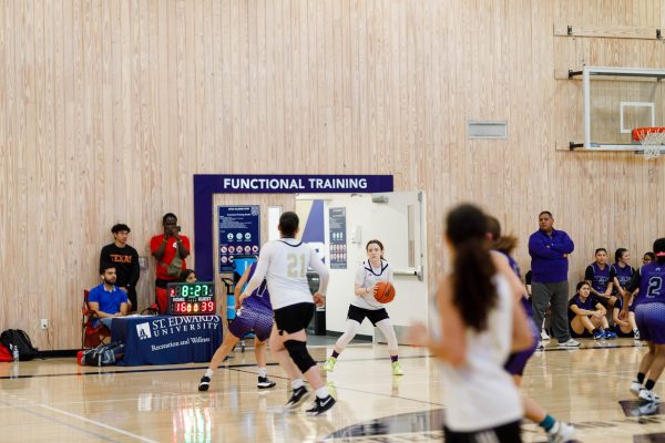 Sydney Carrigans holds the ball and looks upcourt while the team breaks NVC’s full court press. NVC’s head coach, pictured right of Carrigan, kept affirming his team to keep up the press throughout the game.