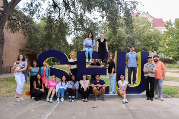 Students from Dr. Nancy Salisbury's Public Relations for Non-Profit class gather at the SEU letters on campus. These communication majors have spent the semester planning every aspect of the upcoming Groovy Goat Music Festival, from social media promotion to event logistics, gaining hands-on experience in non-profit event management.