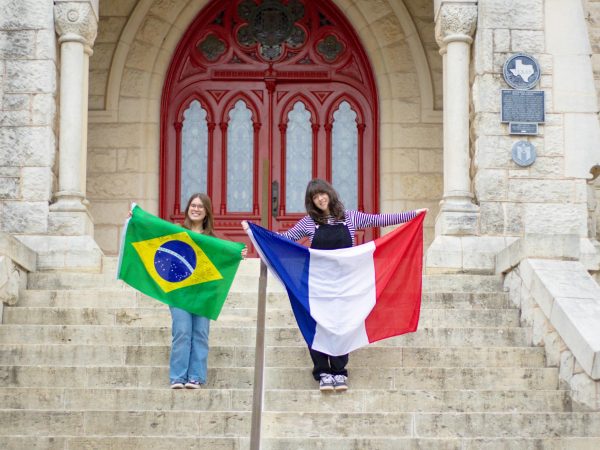 Anna Pratts (left) and Gabrielle Caumon (right) holding the flags of their respective countries in front of St. Edward’s University Main Building. As international students and aspiring journalists, they see the Solutions Journalism grant as an opportunity to shed light on the experience and challenges of studying in another country. 