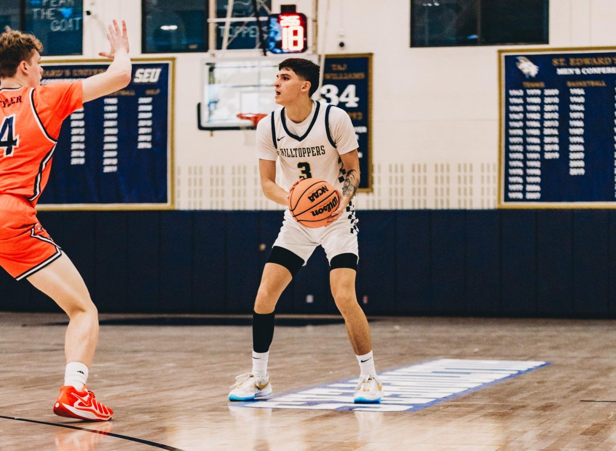 St. Edward’s senior guard Gavino Ramos surveys the defense against UT Tyler during Saturday’s game. Ramos scored 11 consecutive points in the second half and led the Hilltoppers to a win. “It's what I want, I like being in this role,” Ramos said. “I like the guys looking up to me, being the example for them.”