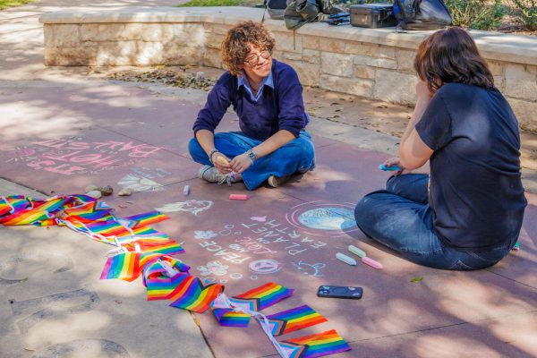  Students used floor chalk to create artworks on the university seal. As students gathered around the seal to remember the day the university came together, they were able to create as well. 